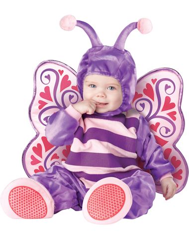 a baby in a purple and pink butterfly costume sitting on top of a white floor