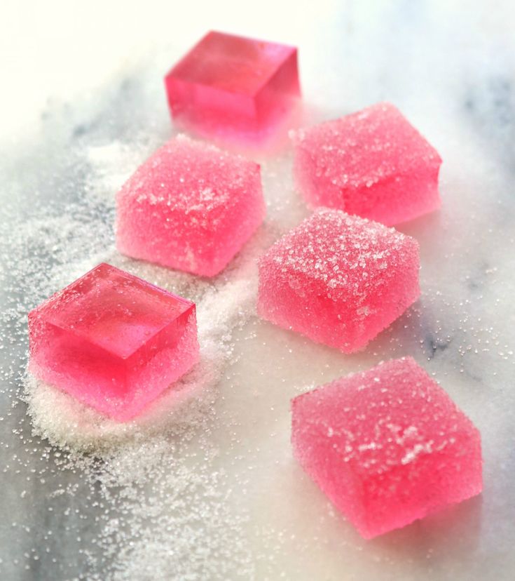 pink sugar cubes sitting on top of a white counter