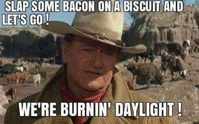 an old man wearing a cowboy hat and looking at the camera with text that reads, slap some bacon on a biscuit and let's go we're burnin'd daylight