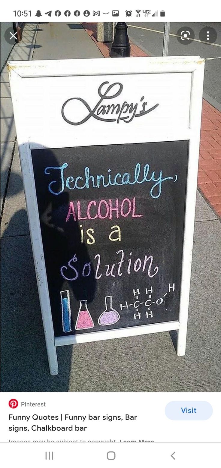 a sign advertising alcohol on the sidewalk