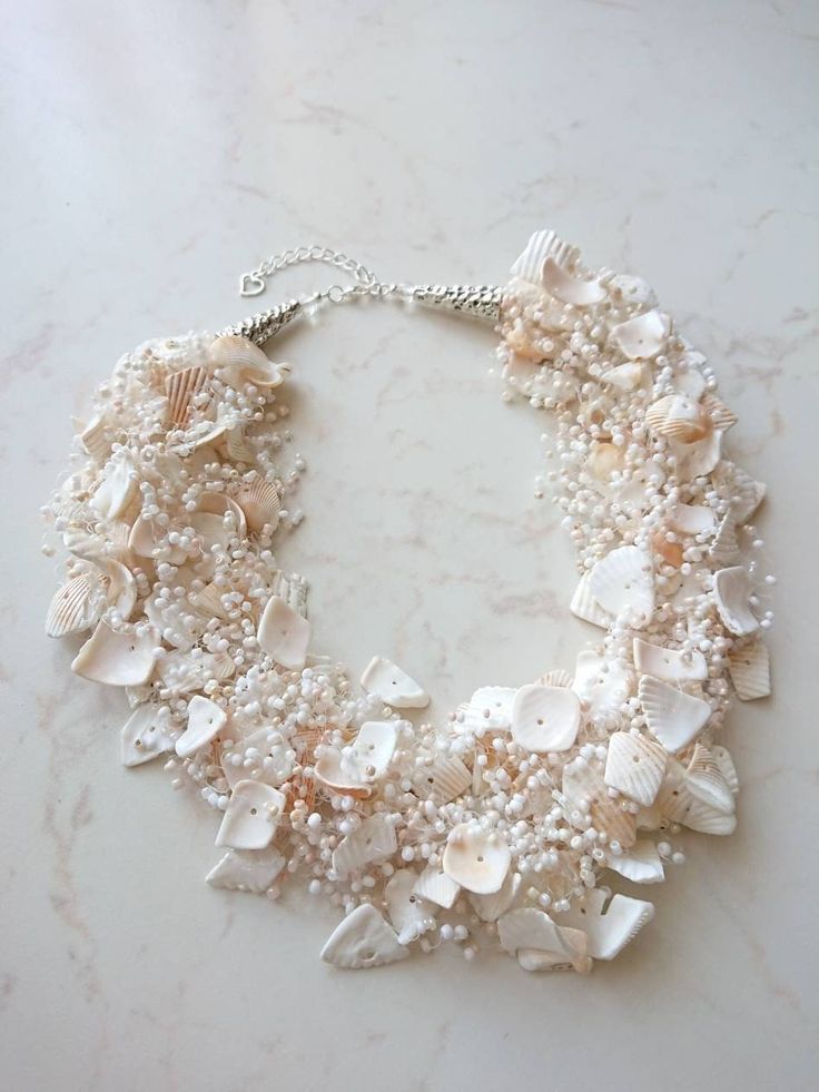 White shells necklace, Beach weddings necklace, Natural shells jewelry, Thick bib necklace, Mermaid style jewelry, Tropical sea necklace set. Crocheted natural shells beach party style necklace with your choose of shell chips and glass seed beads. A light, beautiful and flexible piece of jewelry, it will be a great addition to an evening or a wedding gown. It might be a perfect gift for her for a birthday, anniversary or another occasion. Measure: length (flexible): 48 cm (19 inches) + 4 cm chai Bridal Kaleere, Beach Wedding Necklace, Shells Necklace, Shells Jewelry, White Shells, Seashell Beach, Sea Necklace, Tropical Beach Wedding, Beach Wedding Gown