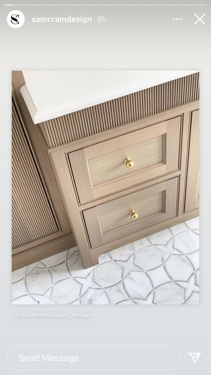 an image of a bathroom vanity with marble counter top and wooden cabinetry on the bottom