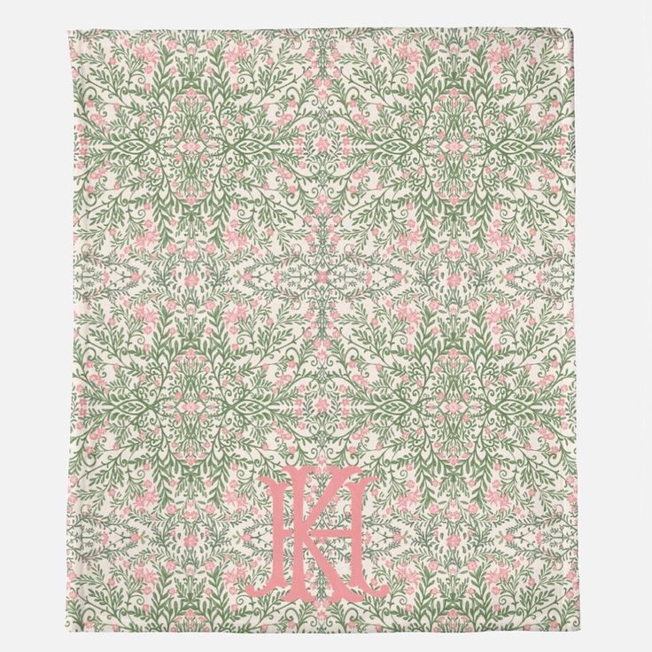 a pink and green floral monogrammed blanket with the letter k on it's side