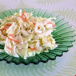 a green plate topped with noodles and meat