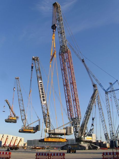 several cranes are in the middle of a construction site