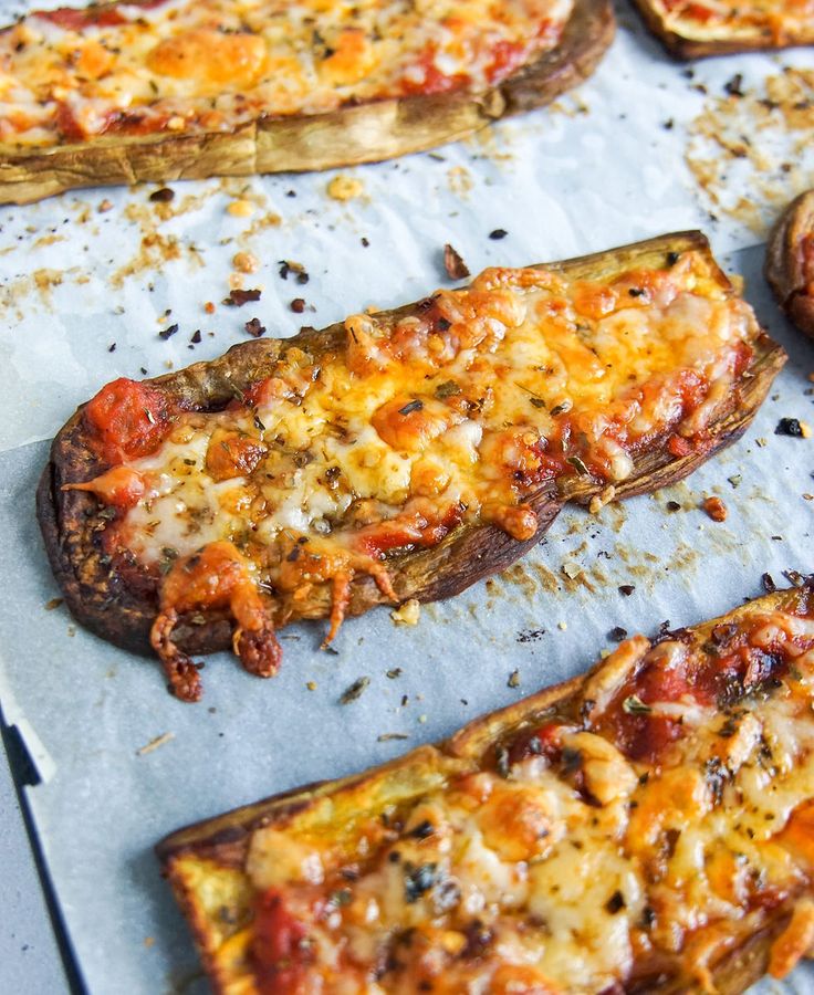 several slices of pizza sitting on top of a baking sheet covered in cheese and toppings