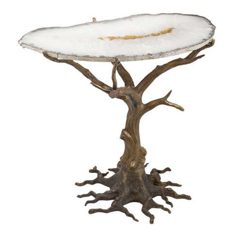 a white stone topped table with tree roots on it's base, against a white background