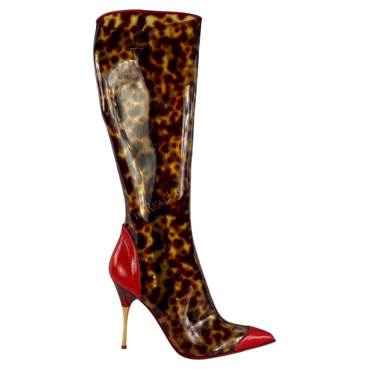 Presenting a pair of spotted brown PVC Roberto Cavalli heeled boots. From the Spring/Summer 2003 collection, these fabulous boots are constructed of spotted brown PVC, reminiscent of tortoiseshell, and feature bright red leather accents. Never worn before, these pointed-heeled boots from over 20 years ago come complete with the original box. Approximate measurements: Size - 39 Width: 3" Heel height: 4" What To Wear With Red Boots, 70s Heels, 2000s Roberto Cavalli, Roberto Cavalli Boots, Roberto Cavalli Heels, Transparent Boots, Zebra Boots, Roberto Cavalli Shoes, Roberto Cavalli Ready To Wear