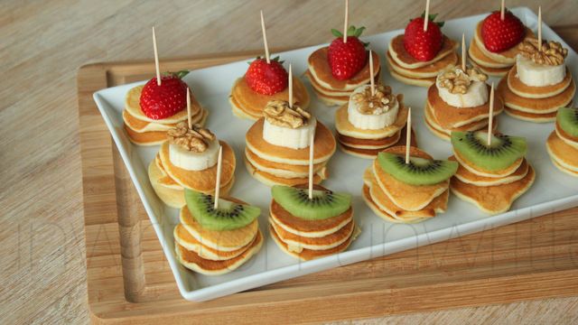 a tray filled with lots of food on top of a wooden table