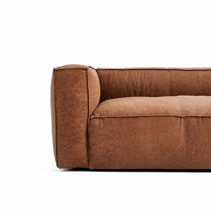 a brown couch sitting on top of a white floor