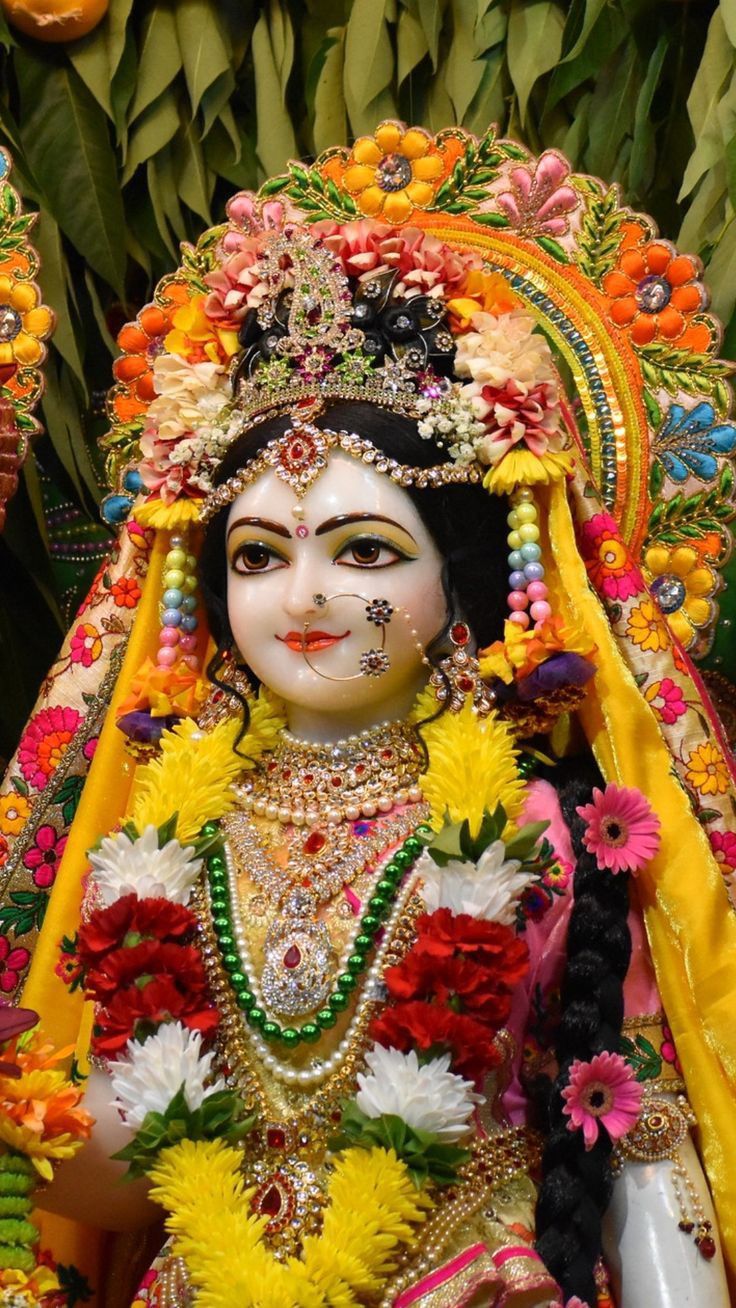 an idol is displayed in front of some flowers