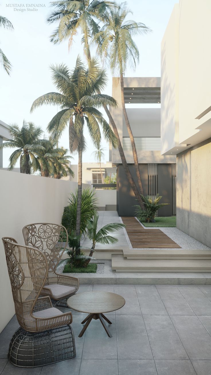 two wicker chairs sitting on top of a tiled floor next to palm trees and stairs