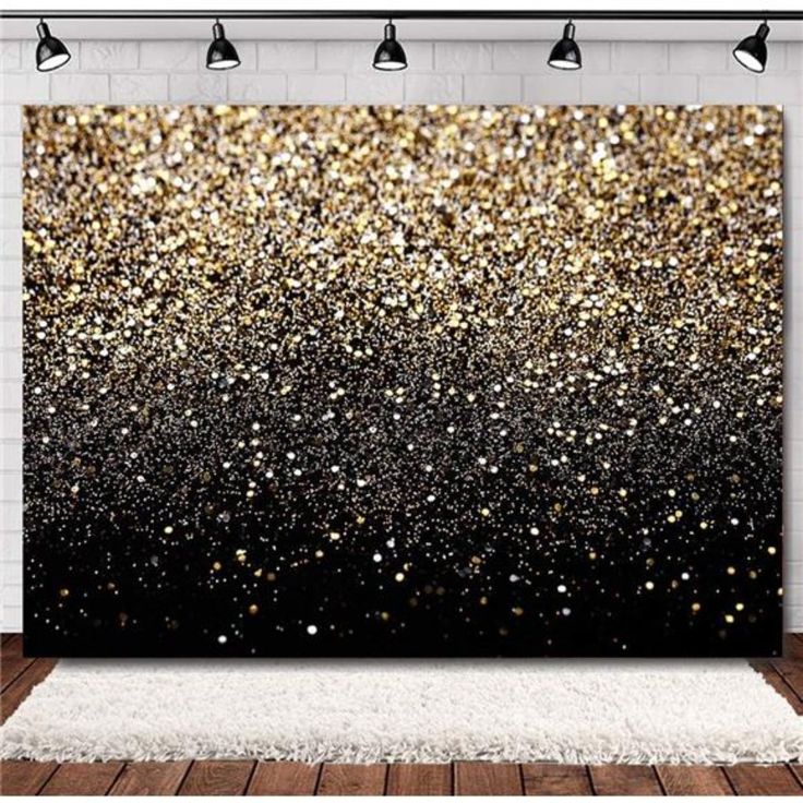 a black and gold wall hanging on a white brick wall next to a wooden floor