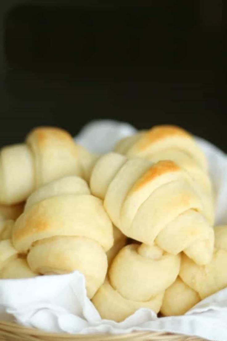 a basket filled with white bread on top of a table