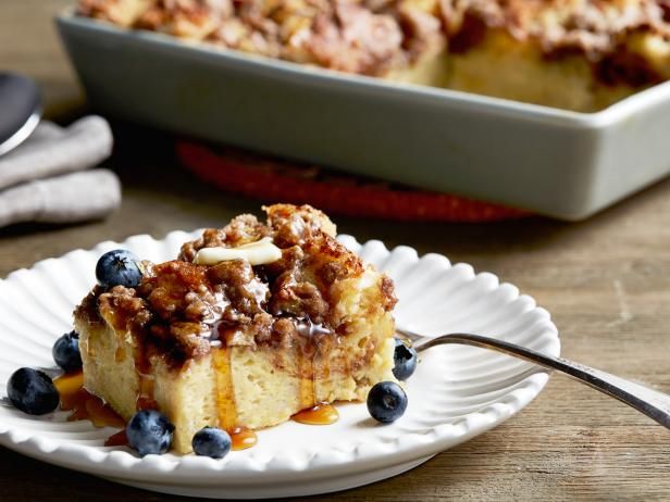 a piece of bread pudding on a plate with blueberries