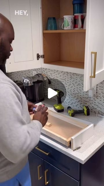 a man standing in front of a kitchen sink