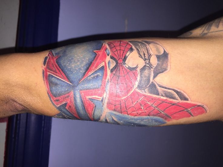 a man with a spiderman tattoo on his arm