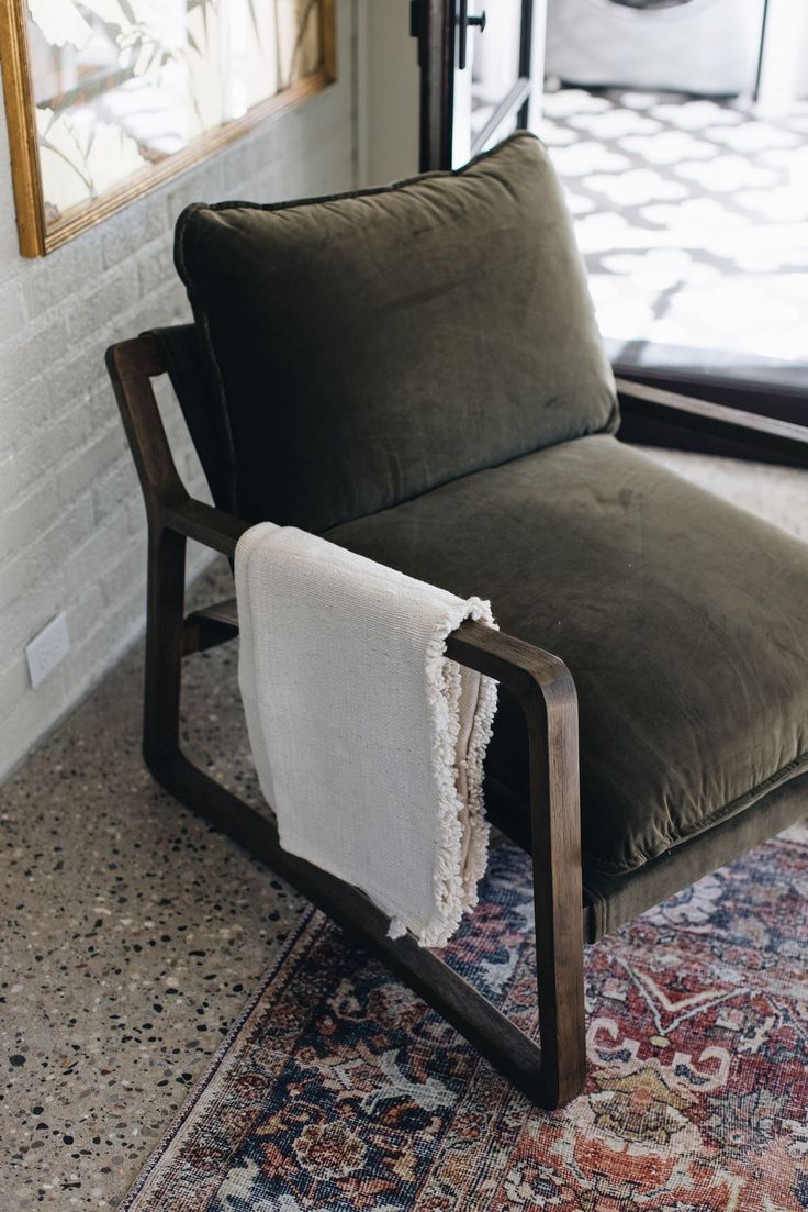 a green chair with a white towel on it