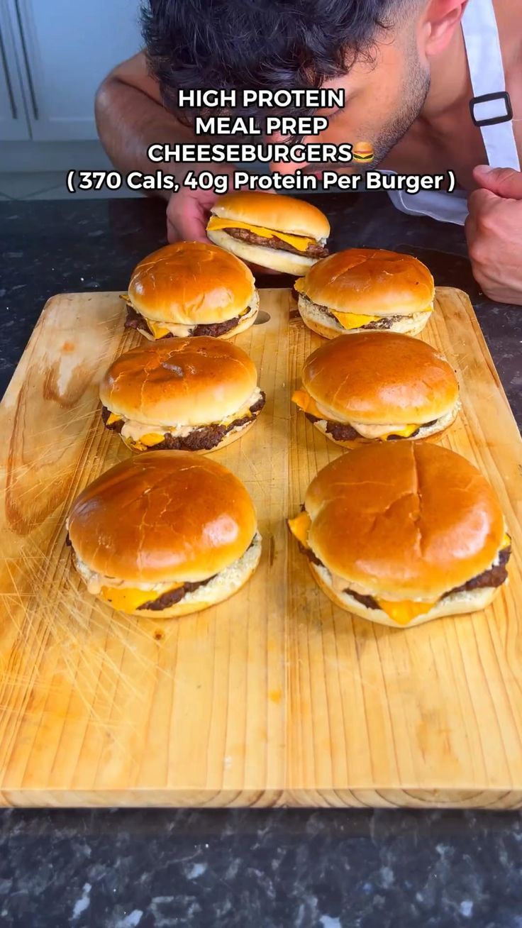 a man is looking at six cheeseburgers on a cutting board with the words high protein cheesy burgers