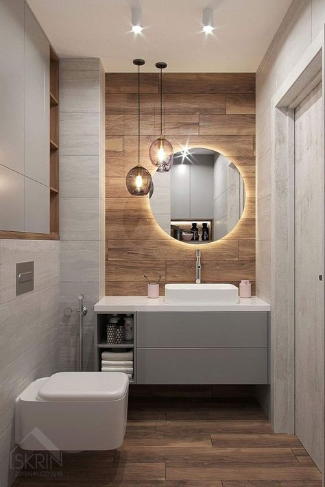 a bathroom with a toilet, sink and mirror on the wall in it's corner