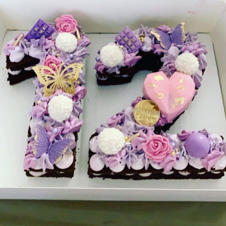 the number twenty two is decorated with flowers and chocolates in pink, purple and white