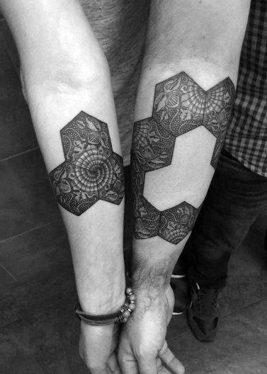 two people with matching tattoos on their arms