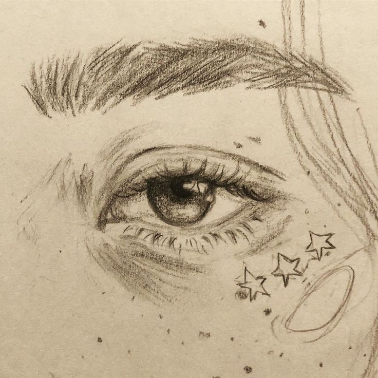 a pencil drawing of an eye with stars on it