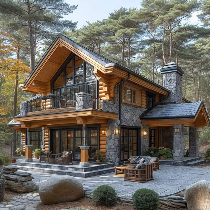 a large log home in the woods surrounded by trees