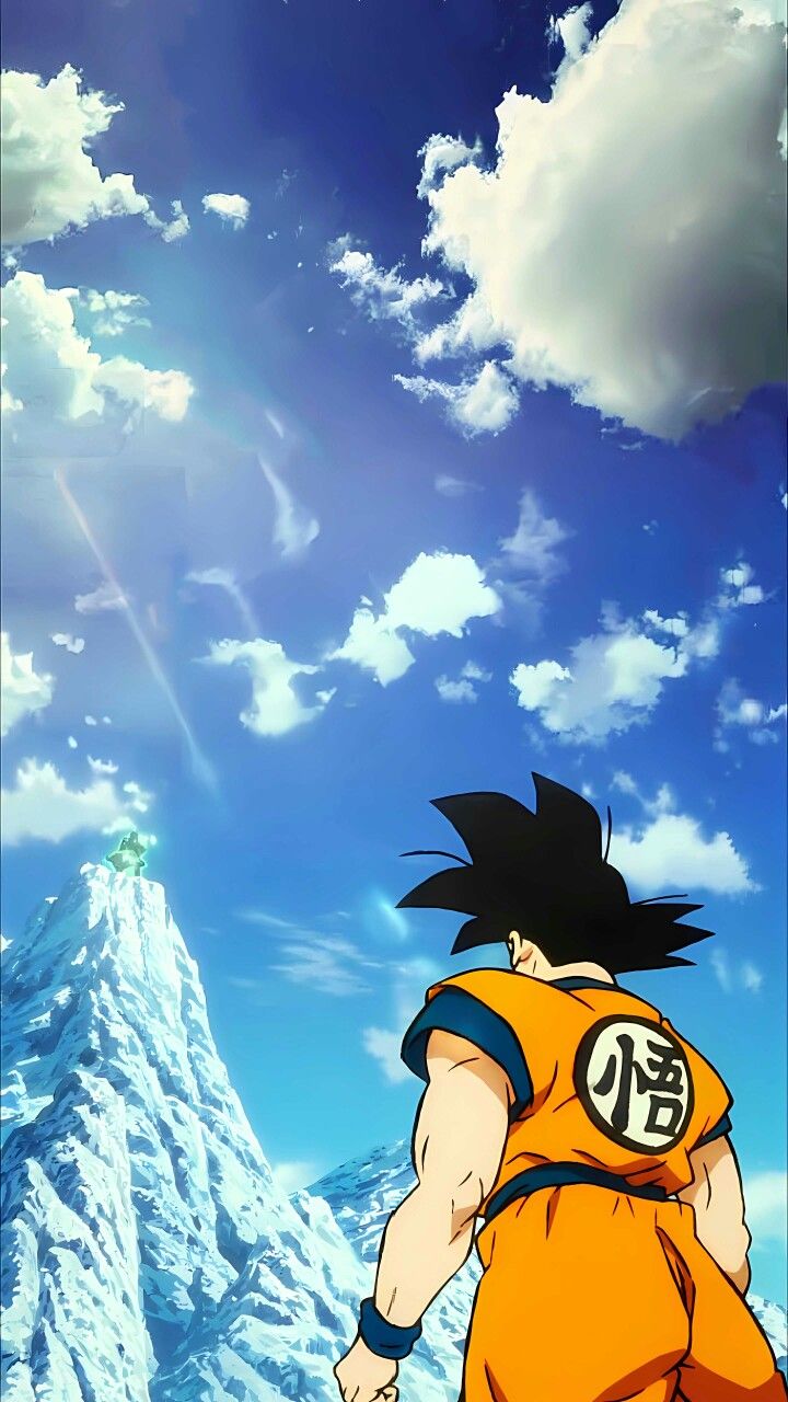 the dragon ball character is standing in front of a snow covered mountain with clouds and blue sky