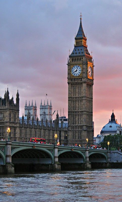 the big ben clock tower towering over the city of london, england at sunset or dawn