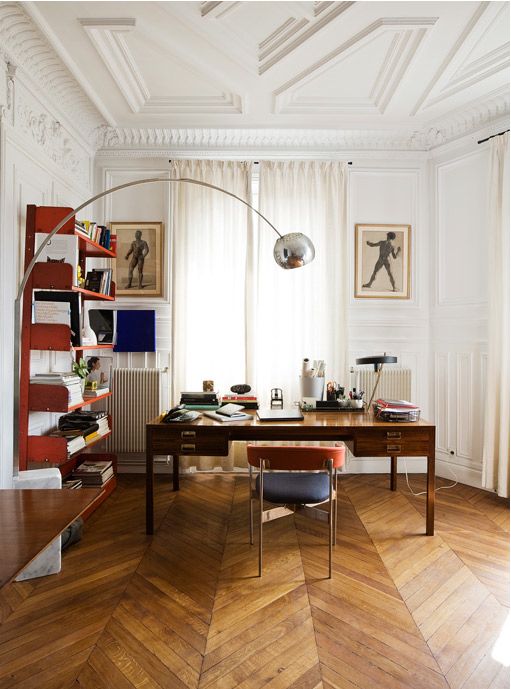 a room with a desk, chair and bookshelf