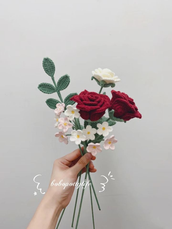 a person is holding some flowers in their hand