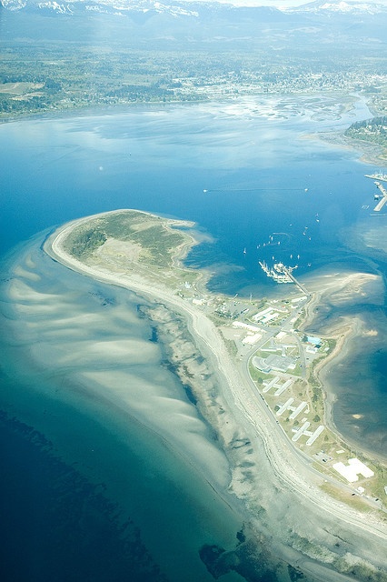 an aerial view of the water and land