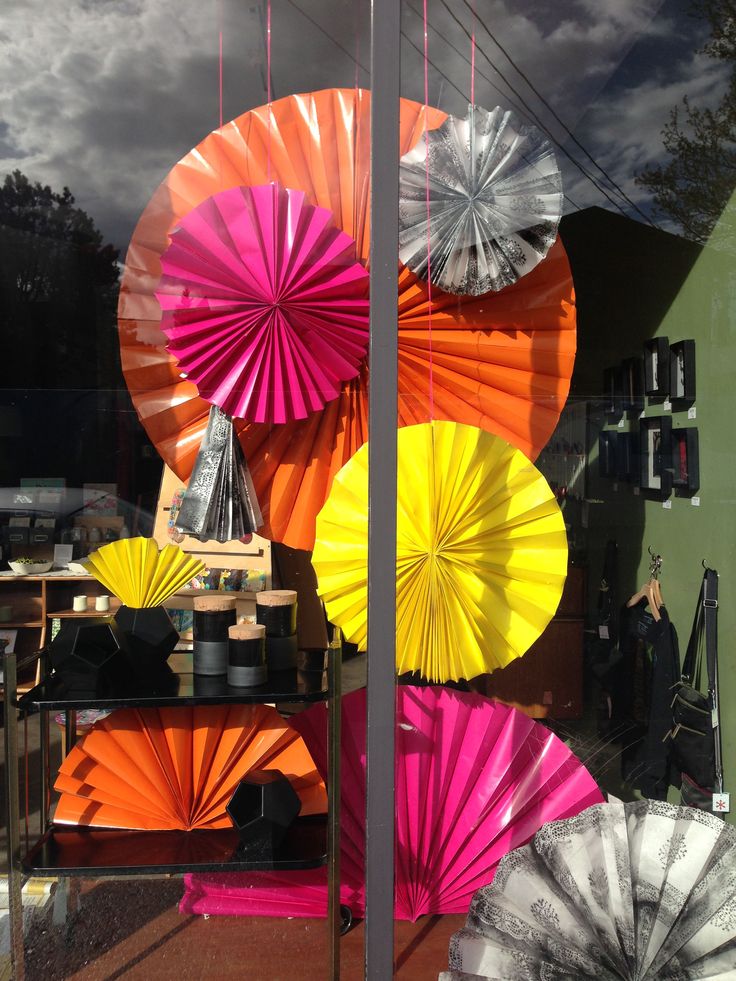 there are many different colored umbrellas in the window