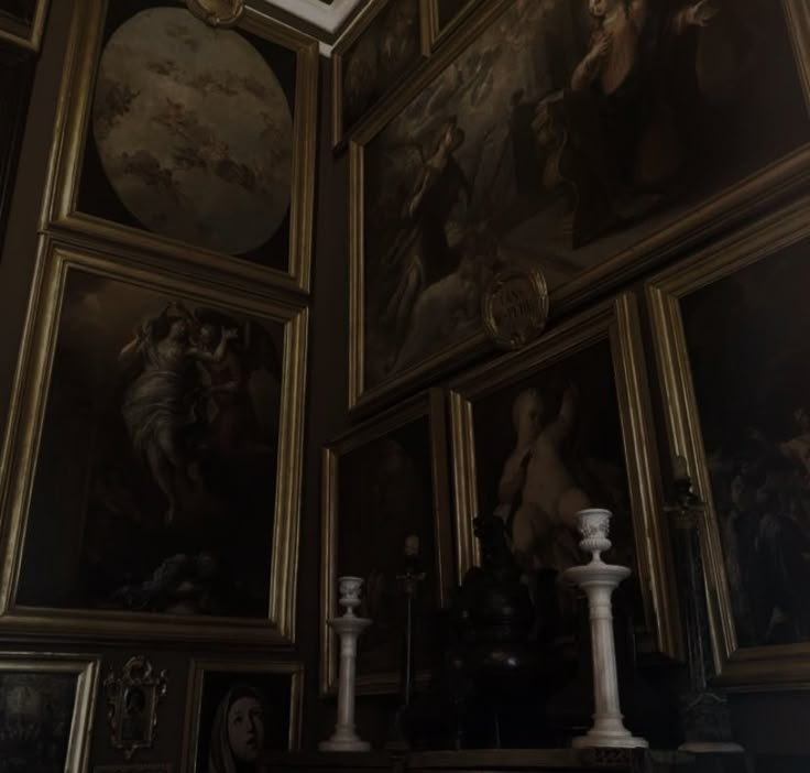 an ornate room with paintings on the wall