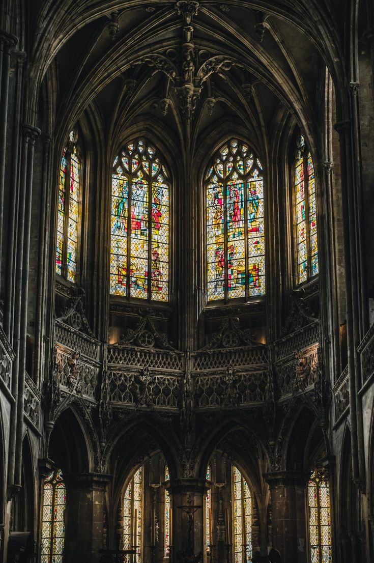 the interior of an old church with stained glass windows