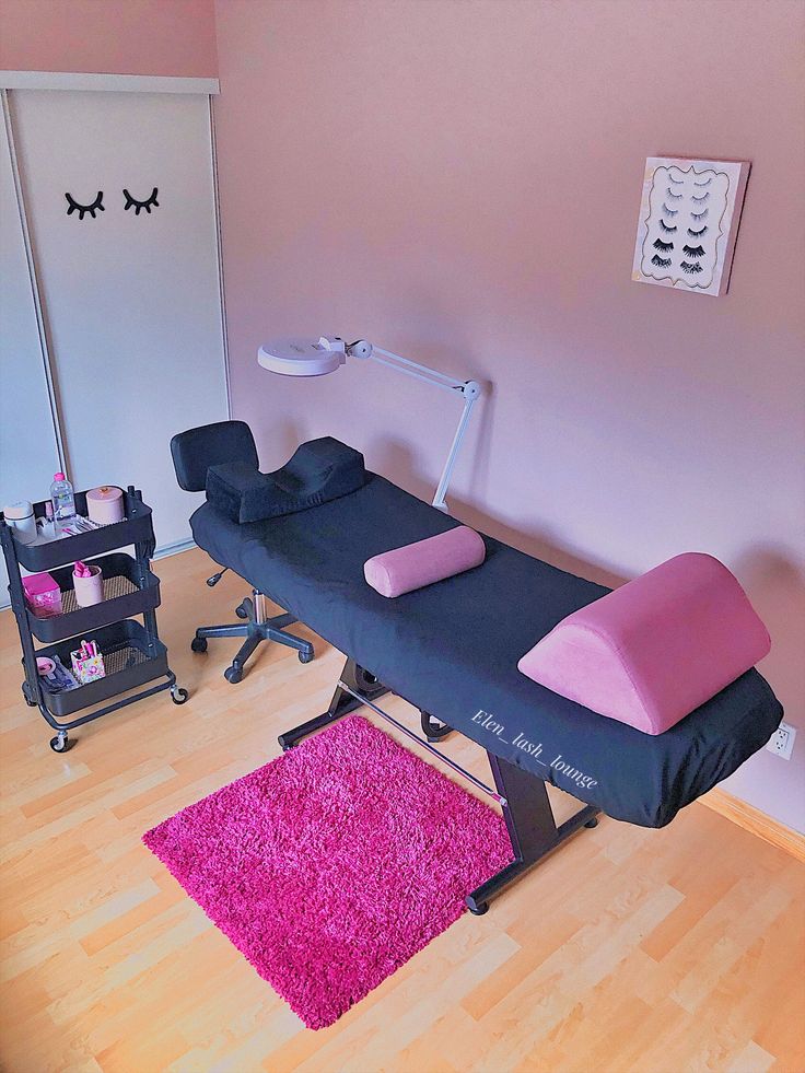 a pink and black beauty room with chairs, rugs and other items on the floor