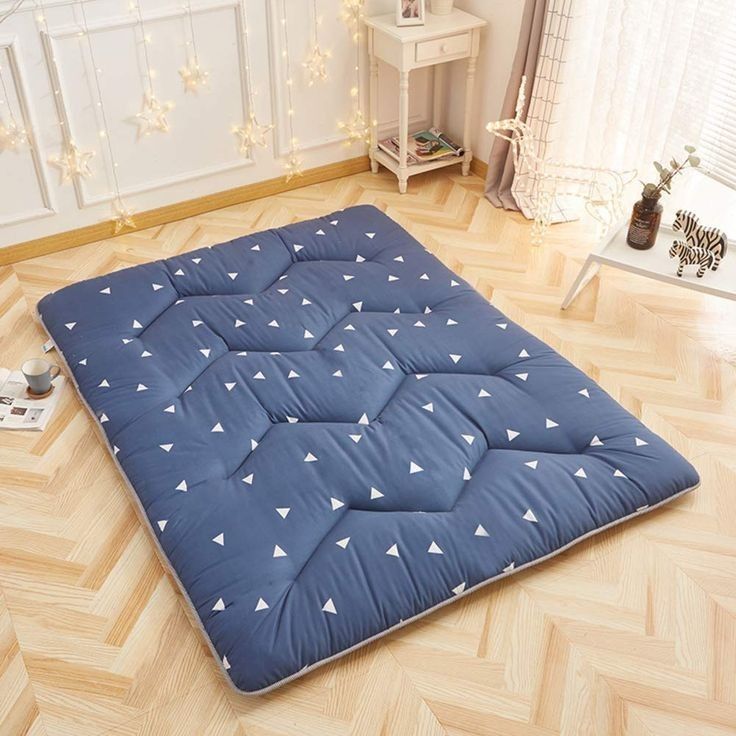 a blue mattress with white triangles on it