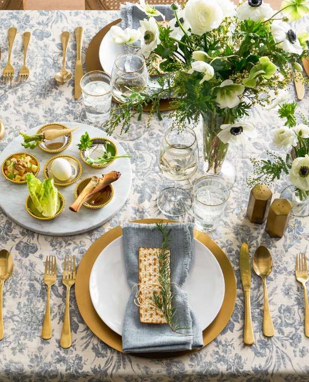 a table set with plates, silverware and flowers