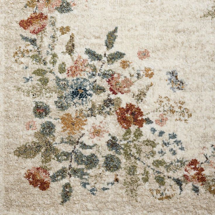 an area rug with flowers and leaves on it