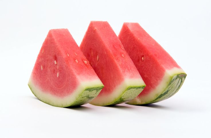 three slices of watermelon on a white background