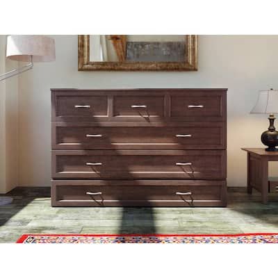 a wooden dresser sitting on top of a rug next to a lamp and table with a mirror