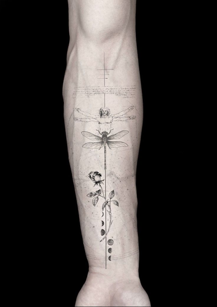 a man's leg with tattoos on it and flowers growing out of the legs