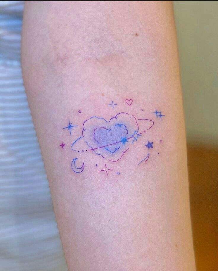 a woman's arm with a small heart and stars tattoo on the left side of her leg