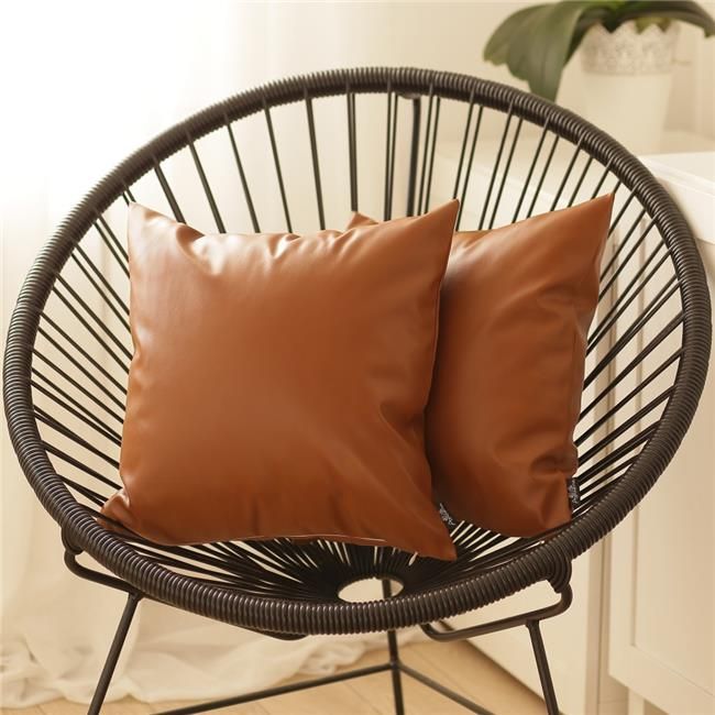 two brown pillows sitting on top of a chair