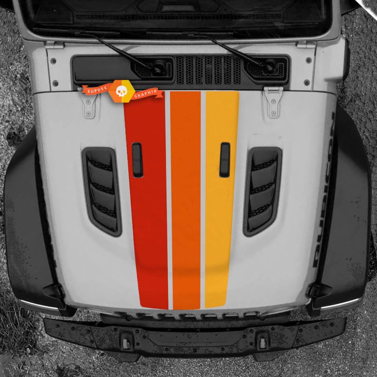 the front end of a truck with an orange and yellow stripe painted on it