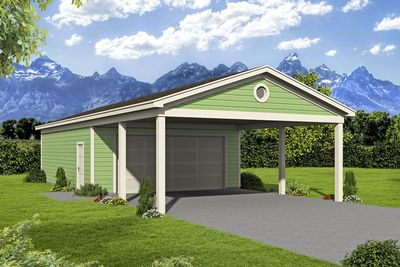 a green garage sitting in the middle of a lush green field with mountains in the background