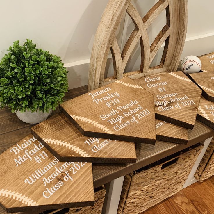 six wooden coasters with names on them sitting on a table next to a potted plant