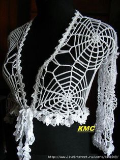 a white crocheted shawl on top of a mannequin's torso