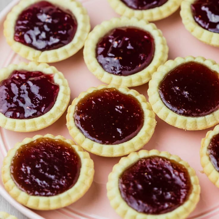 small pies with jelly filling on a pink plate